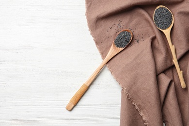 Flat lay composition with poppy seeds on wooden background