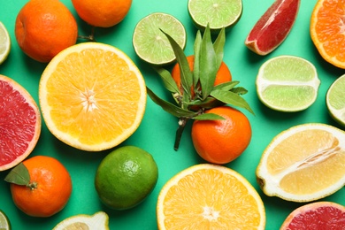 Photo of Different citrus fruits on color background, top view