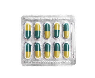 Photo of Pills in blister pack on white background, top view