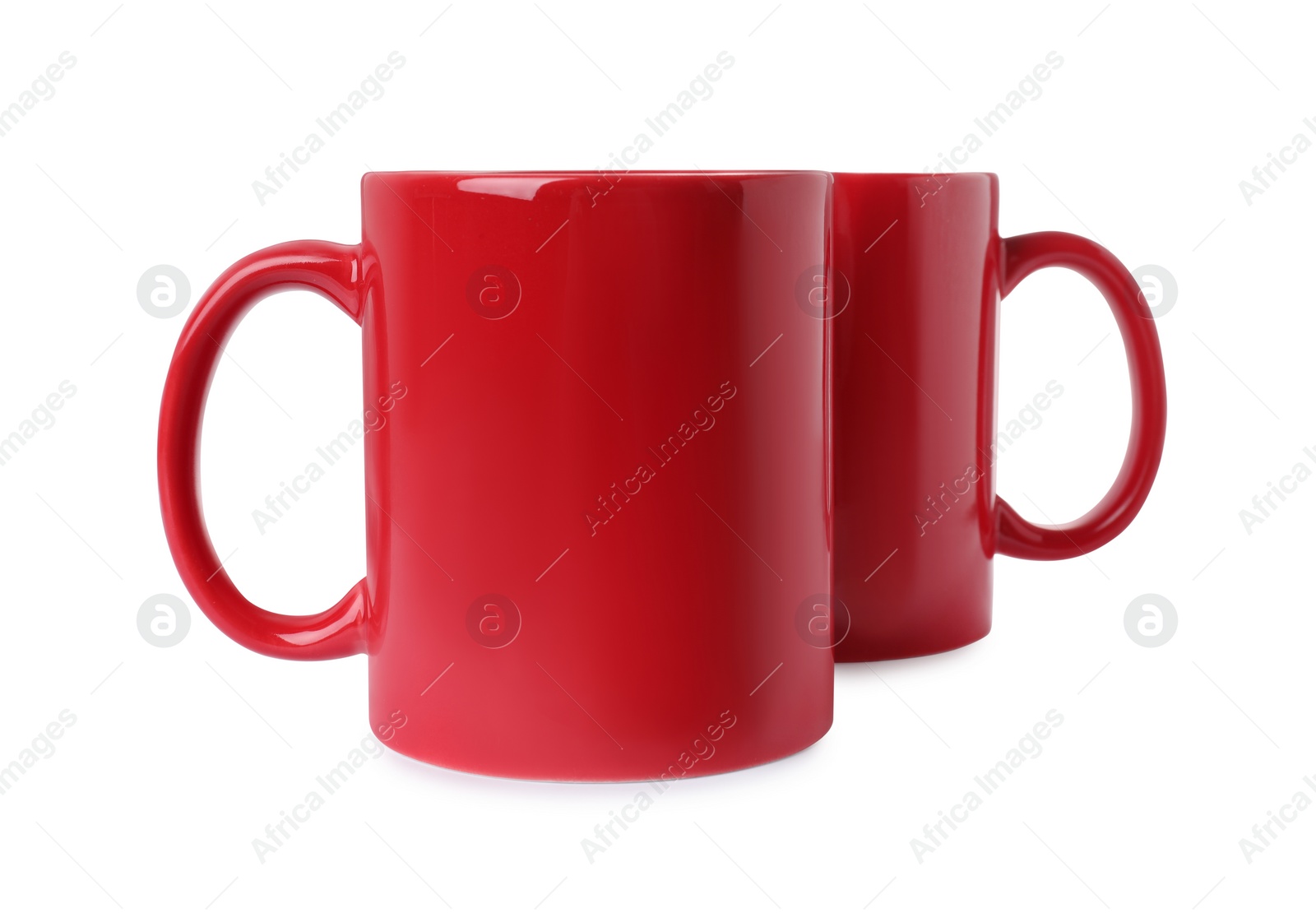 Photo of Two red ceramic mugs isolated on white