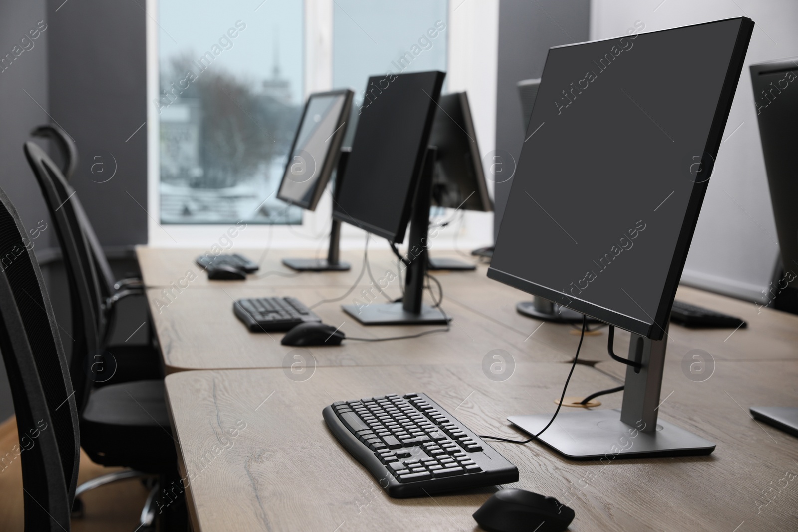 Photo of Many modern computers in open space office