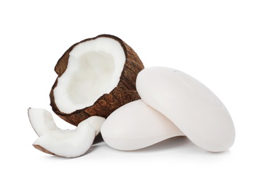Photo of Soap bars and coconut on white background