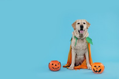 Photo of Cute Labrador Retriever dog in Halloween costume with trick or treat buckets on light blue background. Space for text