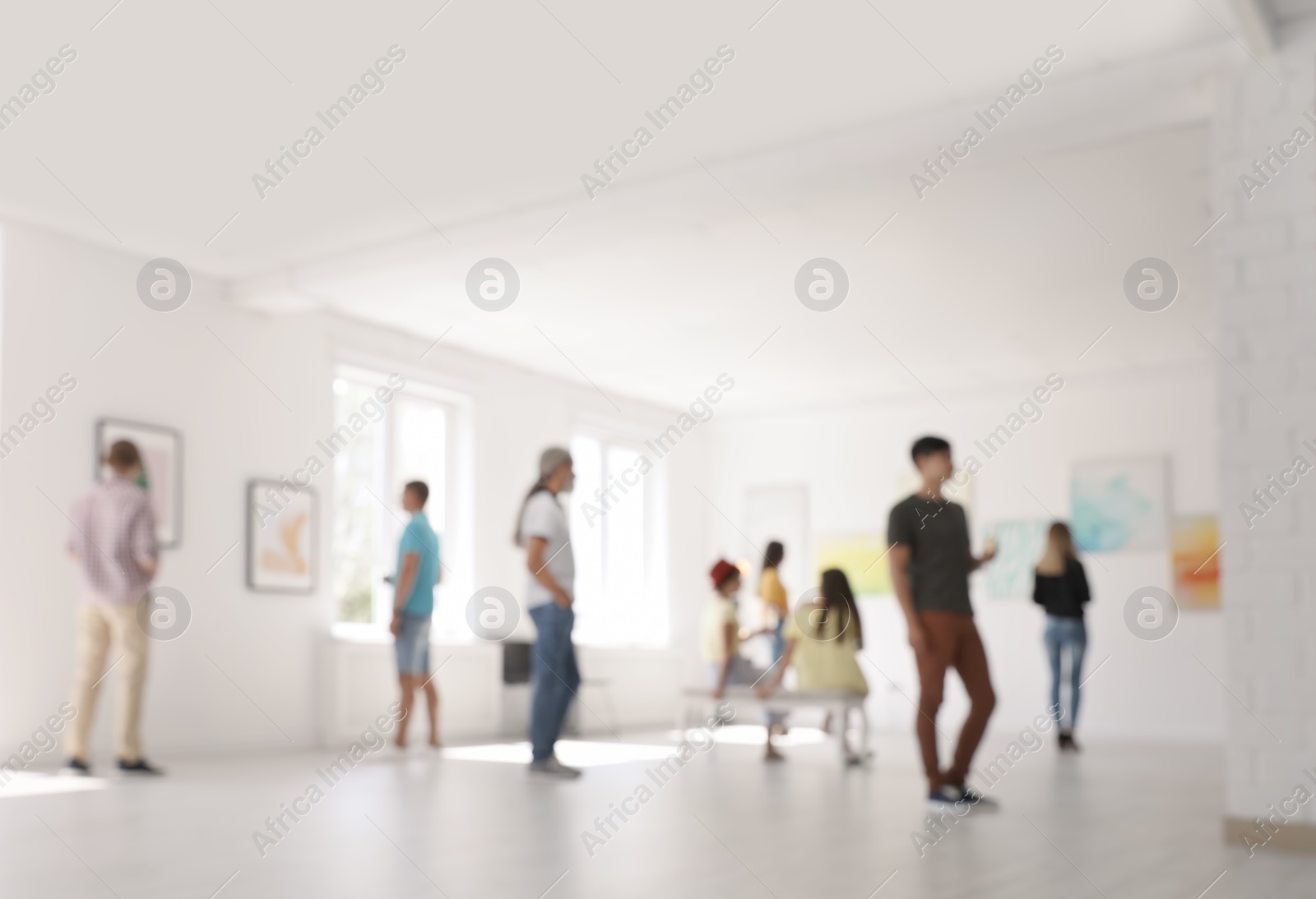 Photo of Blurred view of people at exhibition in art gallery