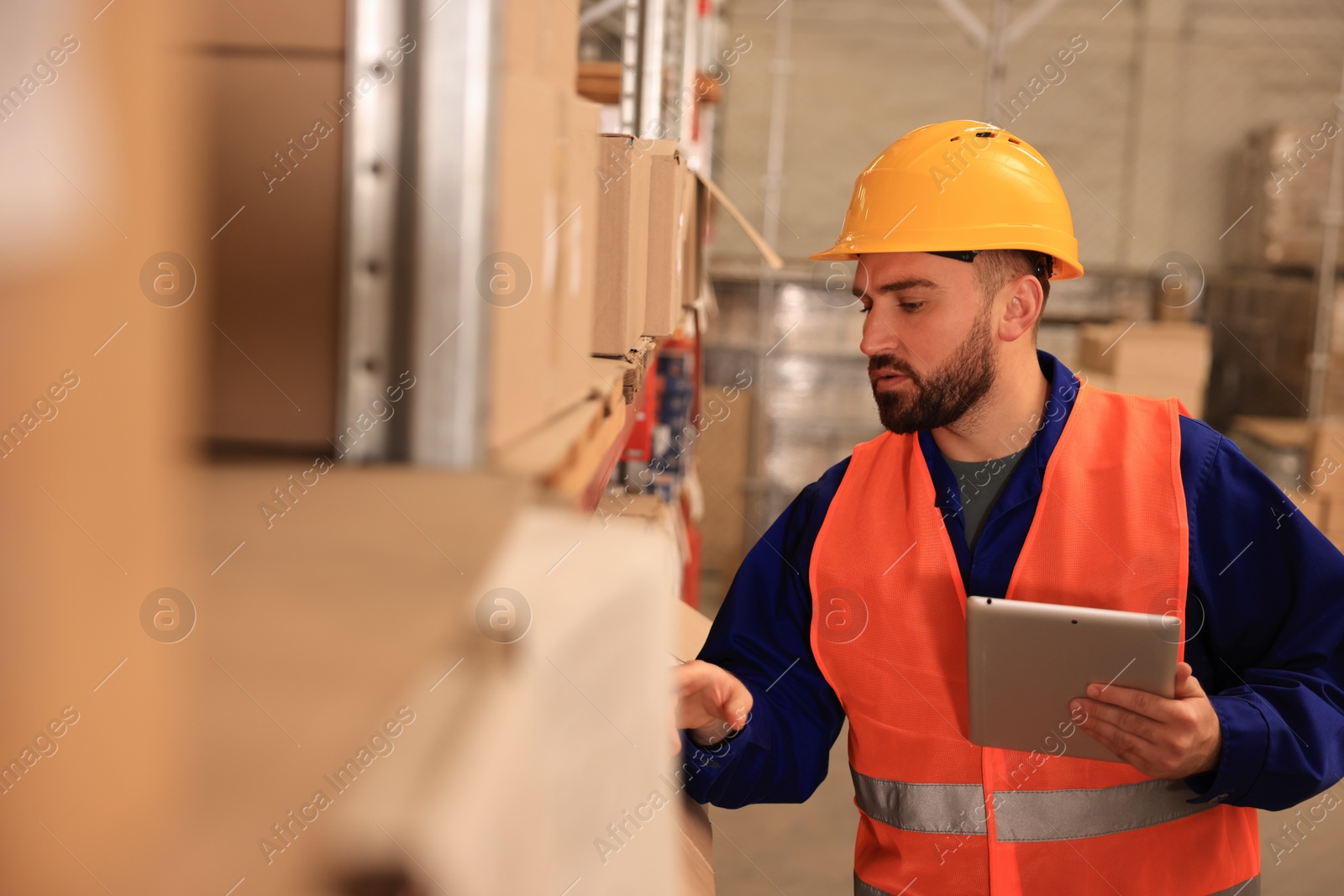 Image of Man with tablet working at warehouse. Logistics center