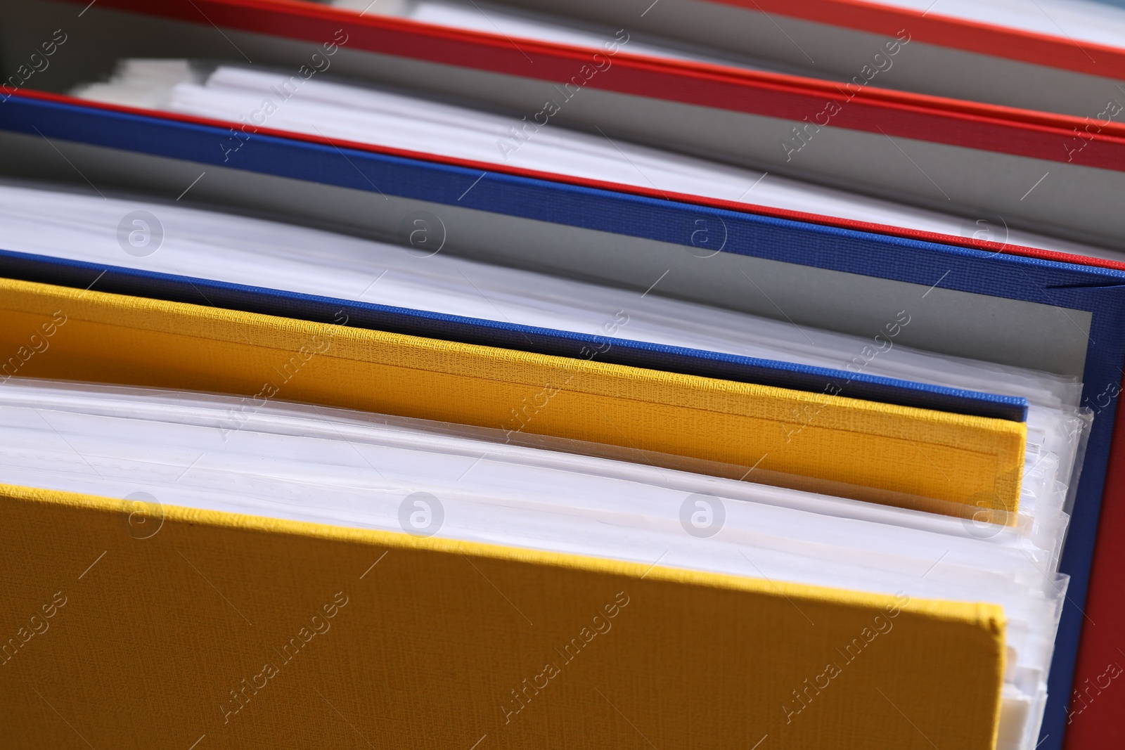 Photo of Colorful binder office folders as background, closeup