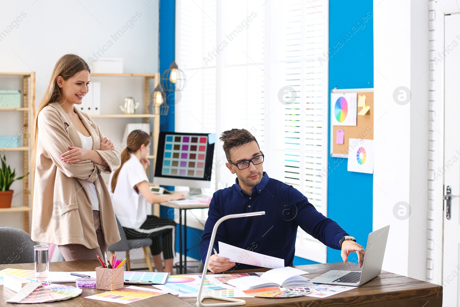 Photo of Professional interior designer with colleague working in office