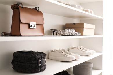 Photo of Storage rack with stylish women's shoes and accessories indoors