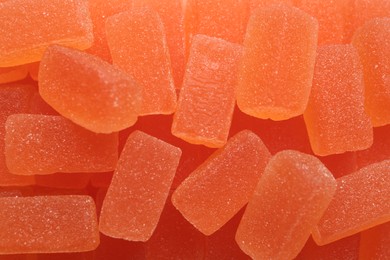 Photo of Tasty orange jelly candies as background, closeup