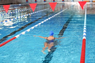 Photo of Young athletic woman swimming in pool