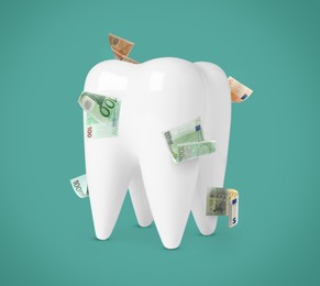 Image of Model of tooth with dollar banknotes on teal background. Concept of expensive dental procedures