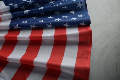 Photo of Flag of USA on light grey table, closeup