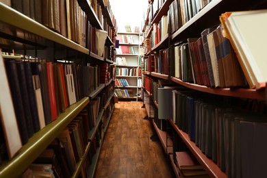 Collection of different books on shelves in library