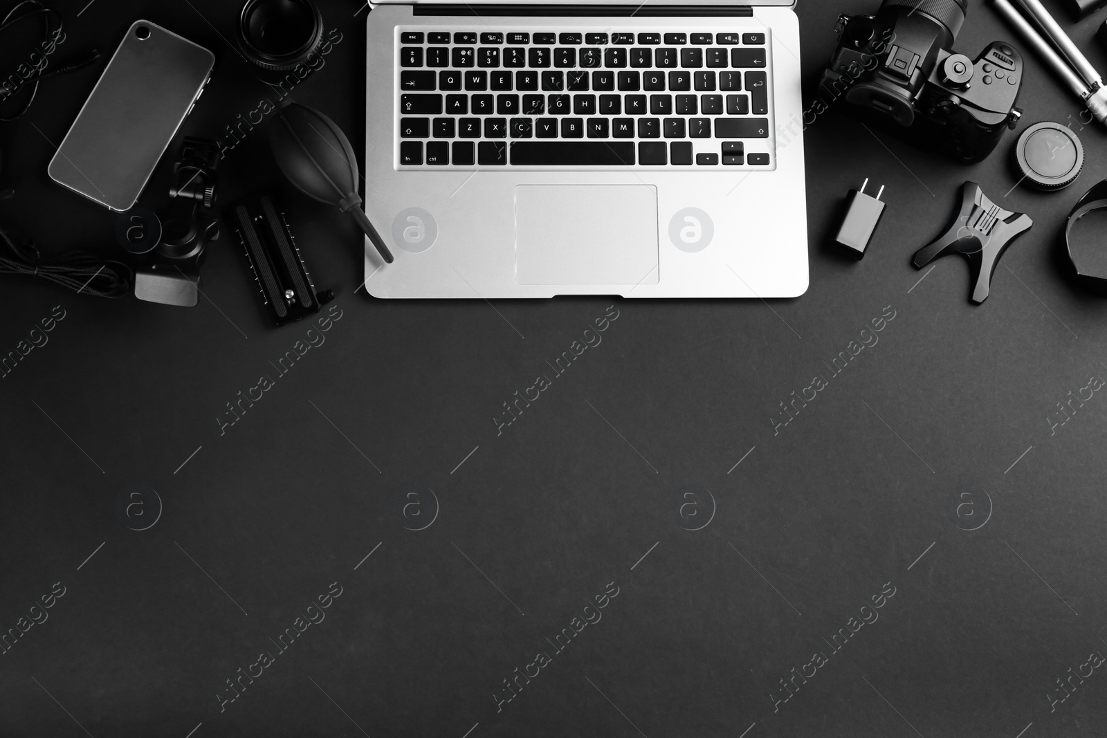 Photo of Flat lay composition with camera and video production equipment on black background, space for text