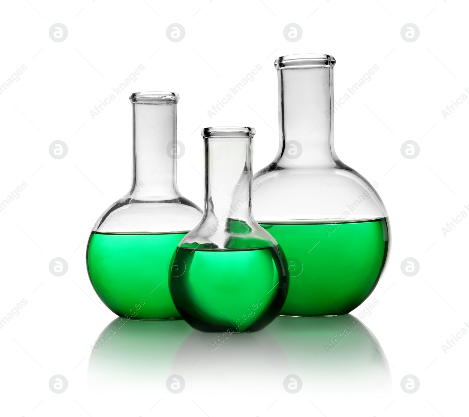 Photo of Florence flasks with green liquid on white background