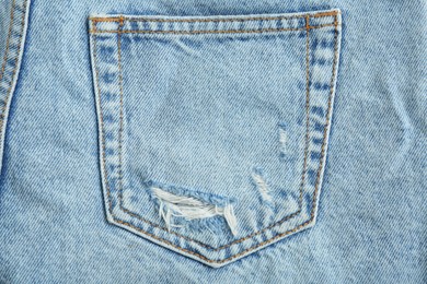 Photo of Stylish light blue jeans, closeup of back pocket
