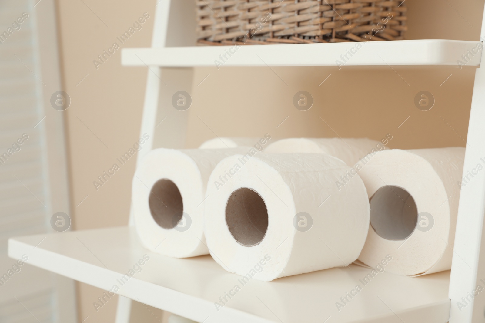 Photo of Toilet paper rolls on shelving unit in bathroom