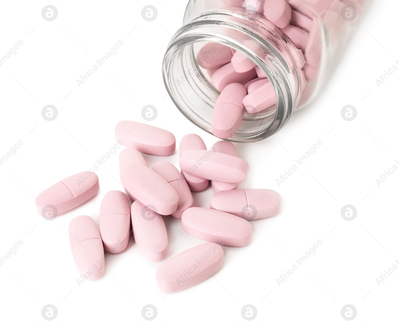 Photo of Scattered vitamin pills and bottle isolated on white