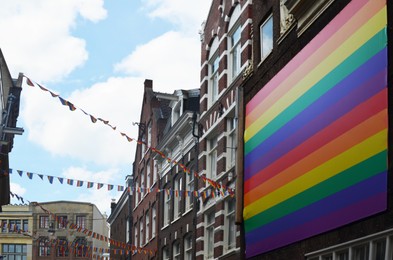 Photo of Picturesque view of city street with rainbow flags