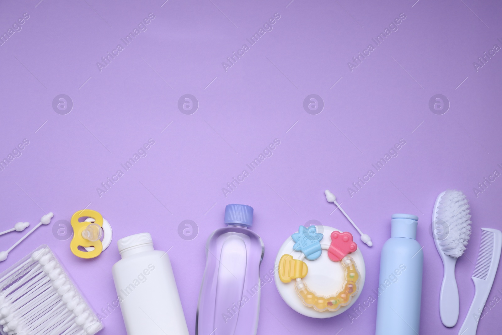 Photo of Flat lay composition with baby care products and accessories on lilac background, space for text