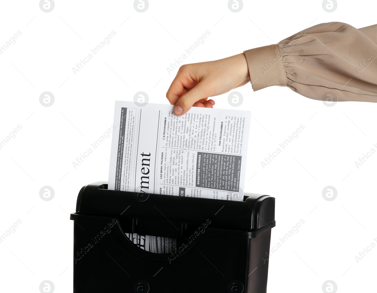 Photo of Woman destroying newspaper with paper shredder on white background, closeup