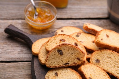 Photo of Sweet hard chuck crackers with raisins on wooden table, closeup