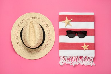 Flat lay composition with different beach objects on pink background