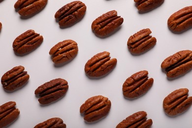 Delicious fresh pecan nuts on white background, flat lay