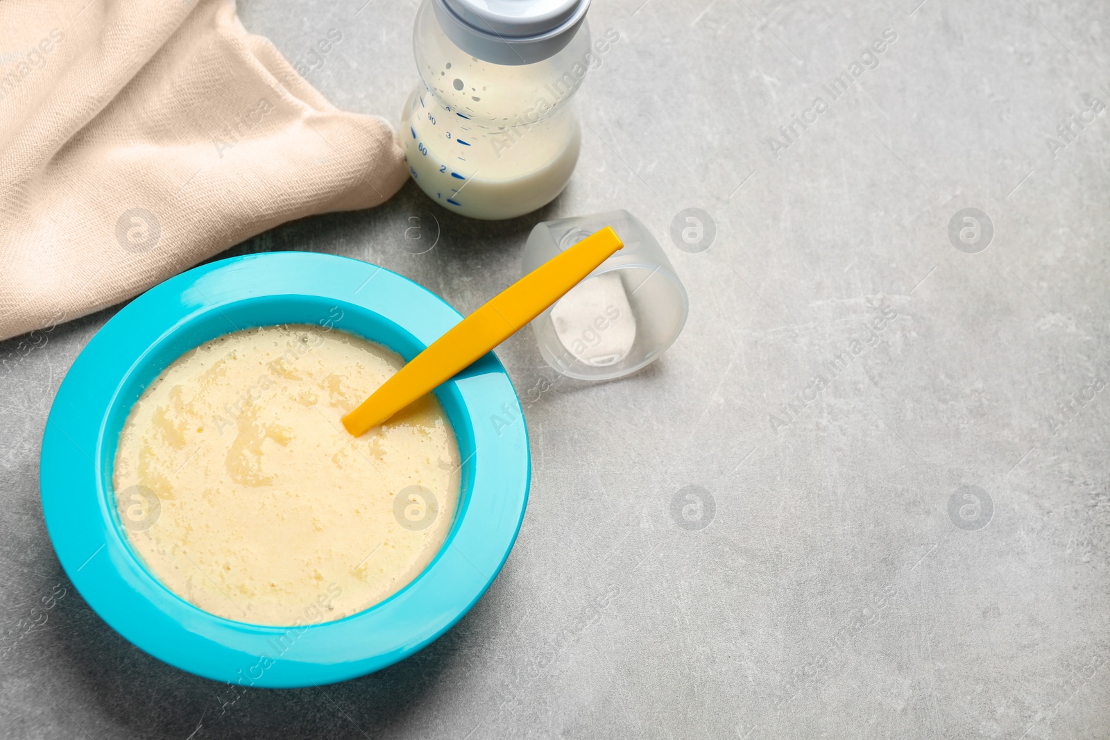 Photo of Healthy baby food on grey table. Space for text