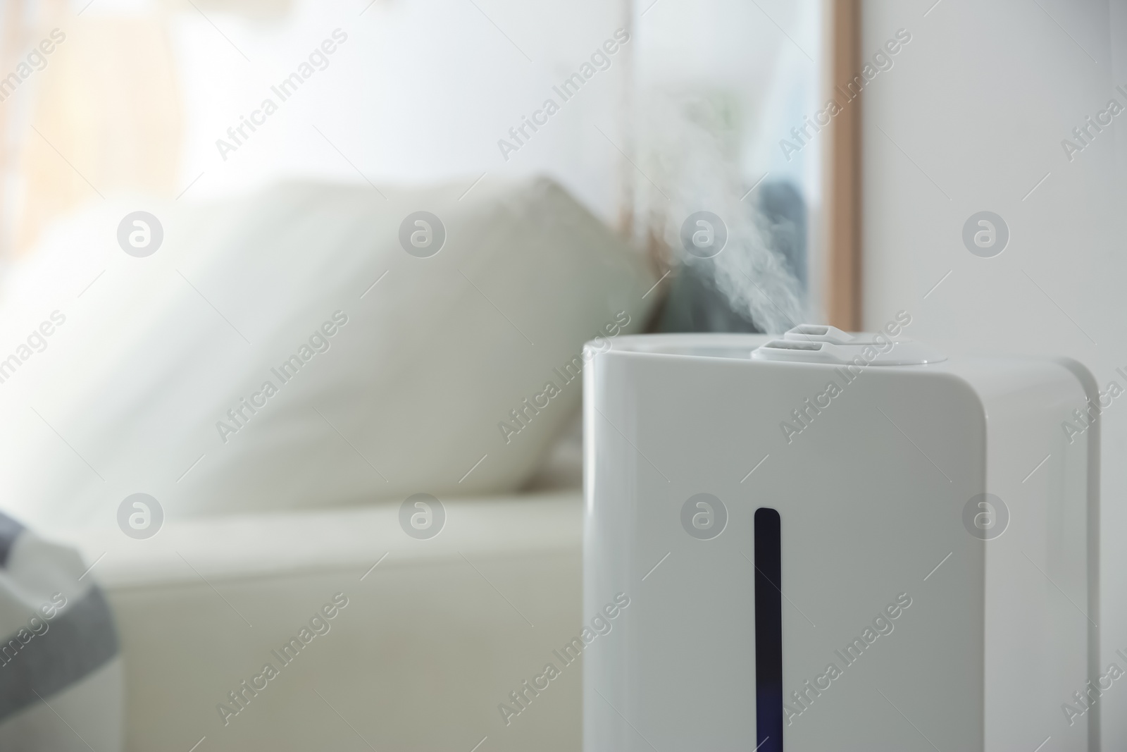 Photo of Modern humidifier indoors, closeup. Space for text