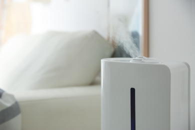 Photo of Modern humidifier indoors, closeup. Space for text