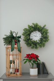 Wooden decorative Christmas lantern on grey table indoors