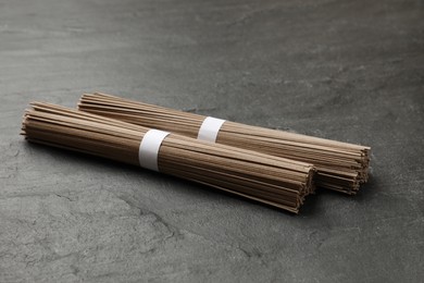 Photo of Uncooked buckwheat noodles (soba) on black table