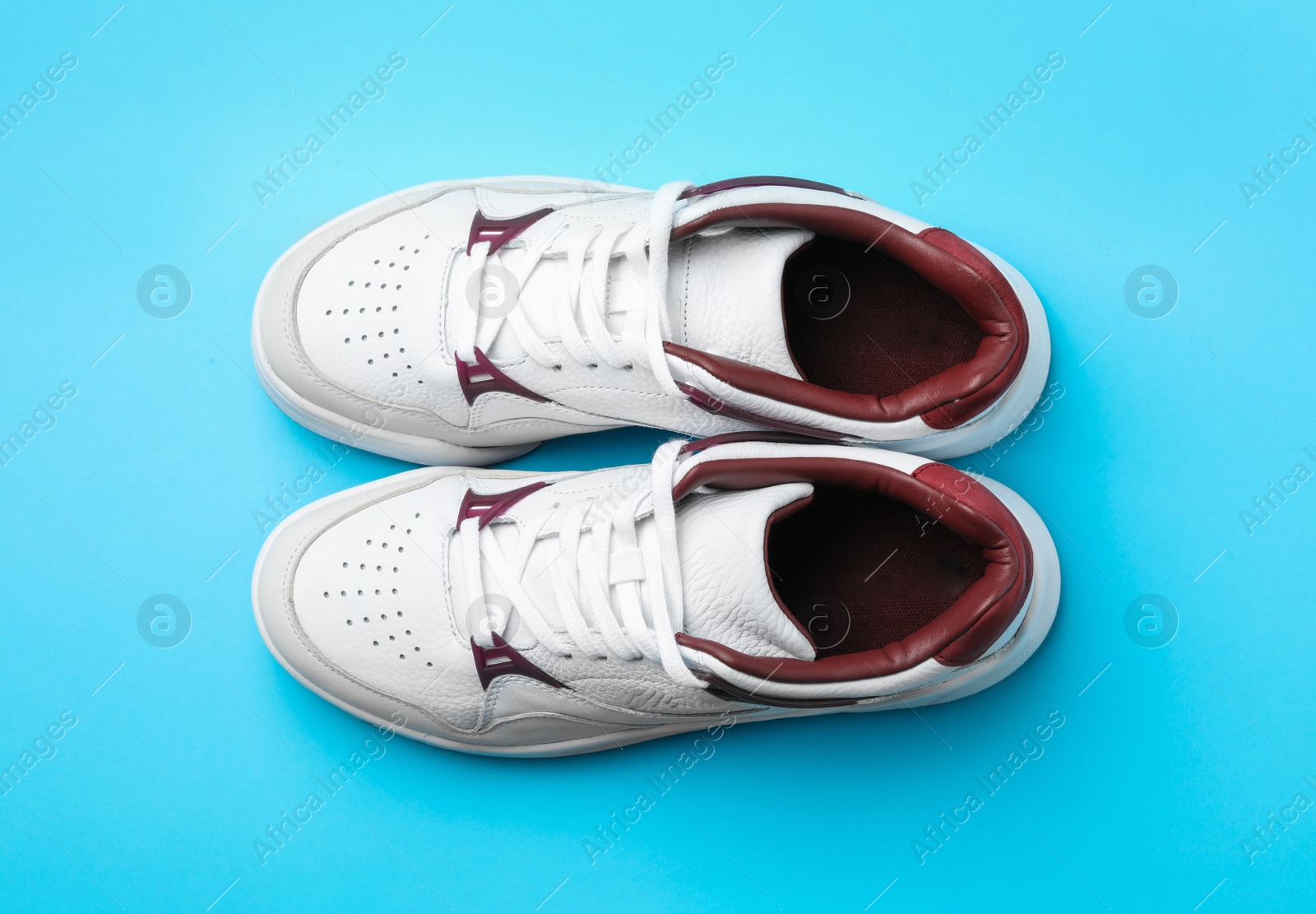 Photo of Pair of stylish shoes on blue background, top view