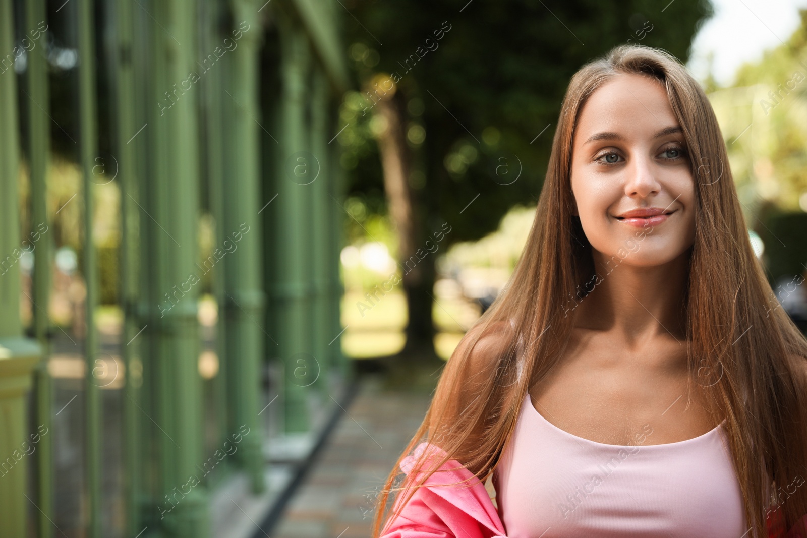 Photo of Portrait of beautiful young woman outdoors, space for text