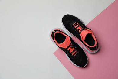 Pair of stylish sport shoes on color background, flat lay. Space for text