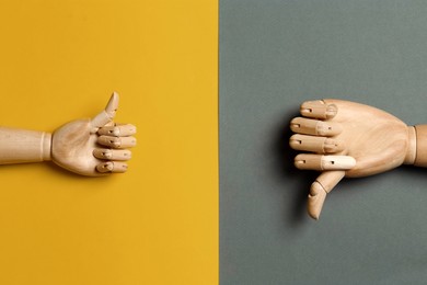 Photo of Wooden mannequin hands on color background, flat lay