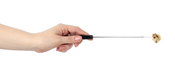 Tasty fondue. Woman holding fork with walnut and melted cheese on white background, closeup