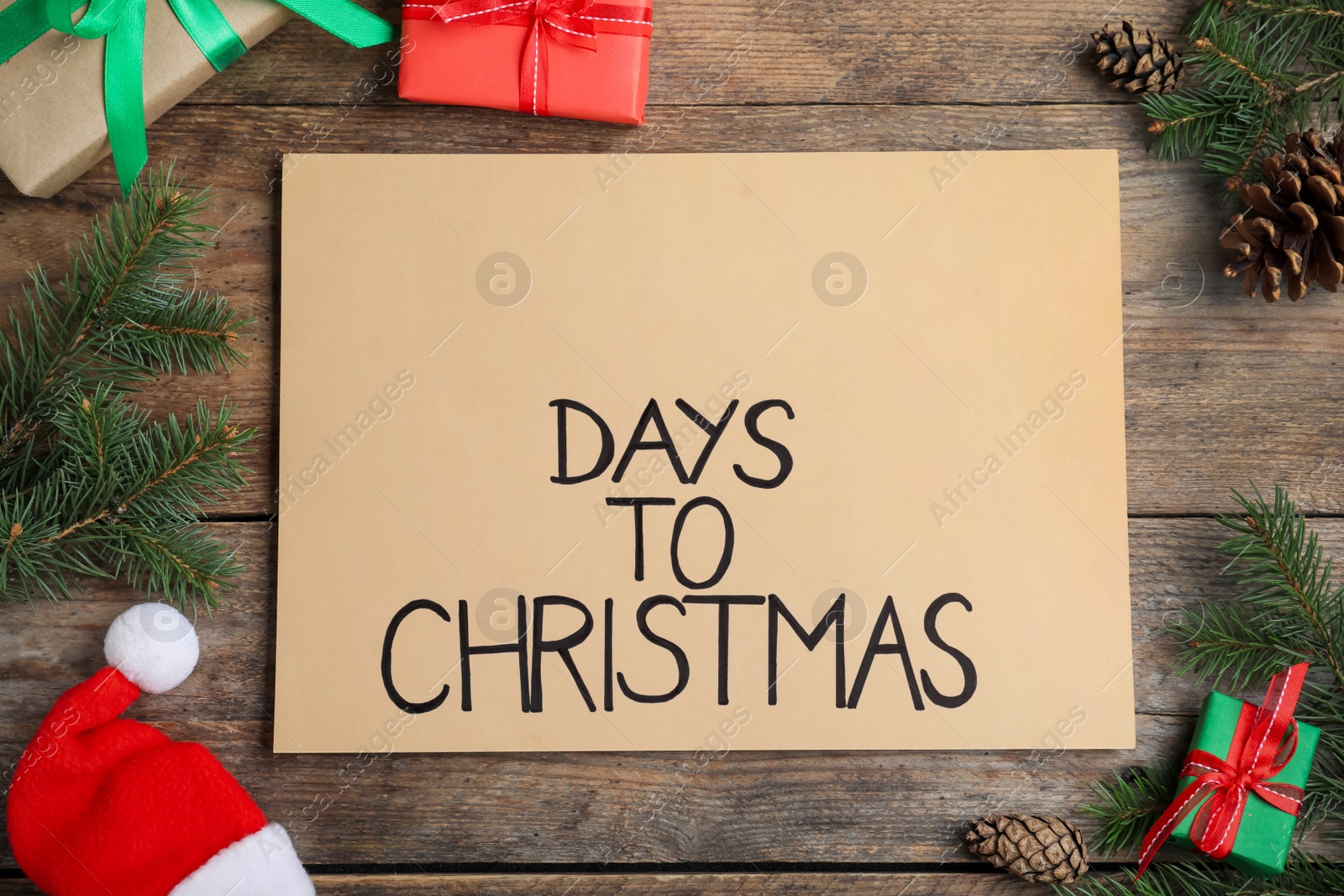 Photo of Flat lay composition of card with words Days To Christmas and space for text on wooden table. Holiday countdown