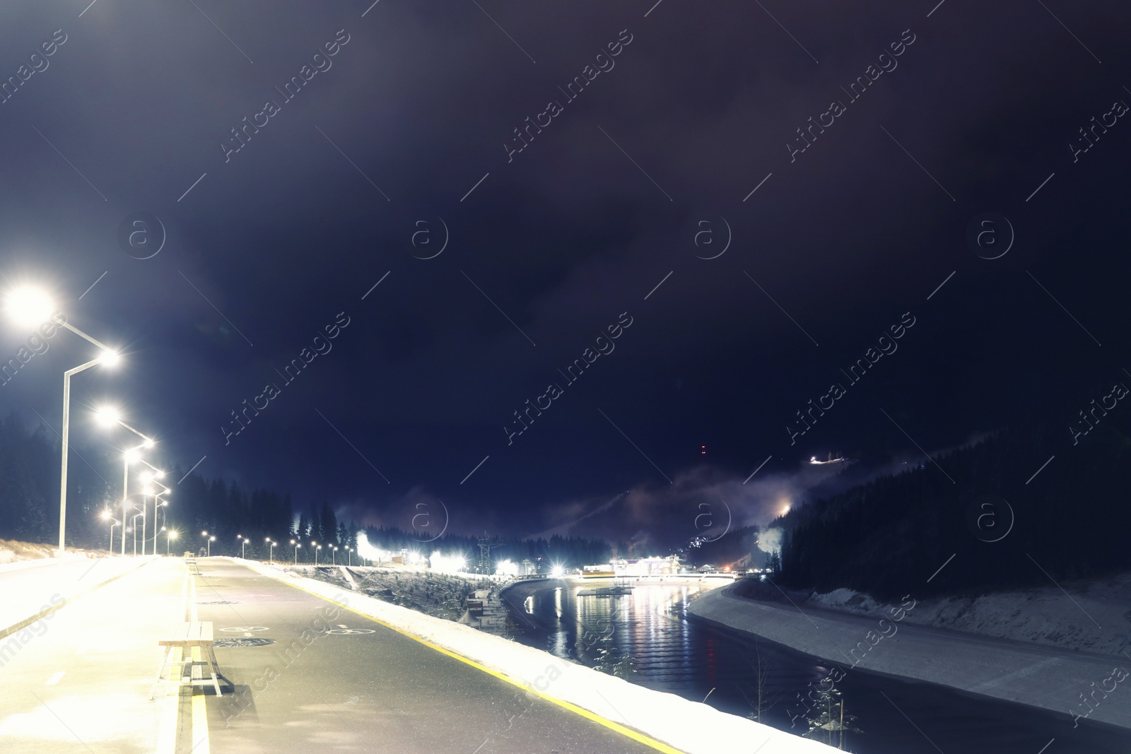 Photo of View of mountain resort near forest at night in winter
