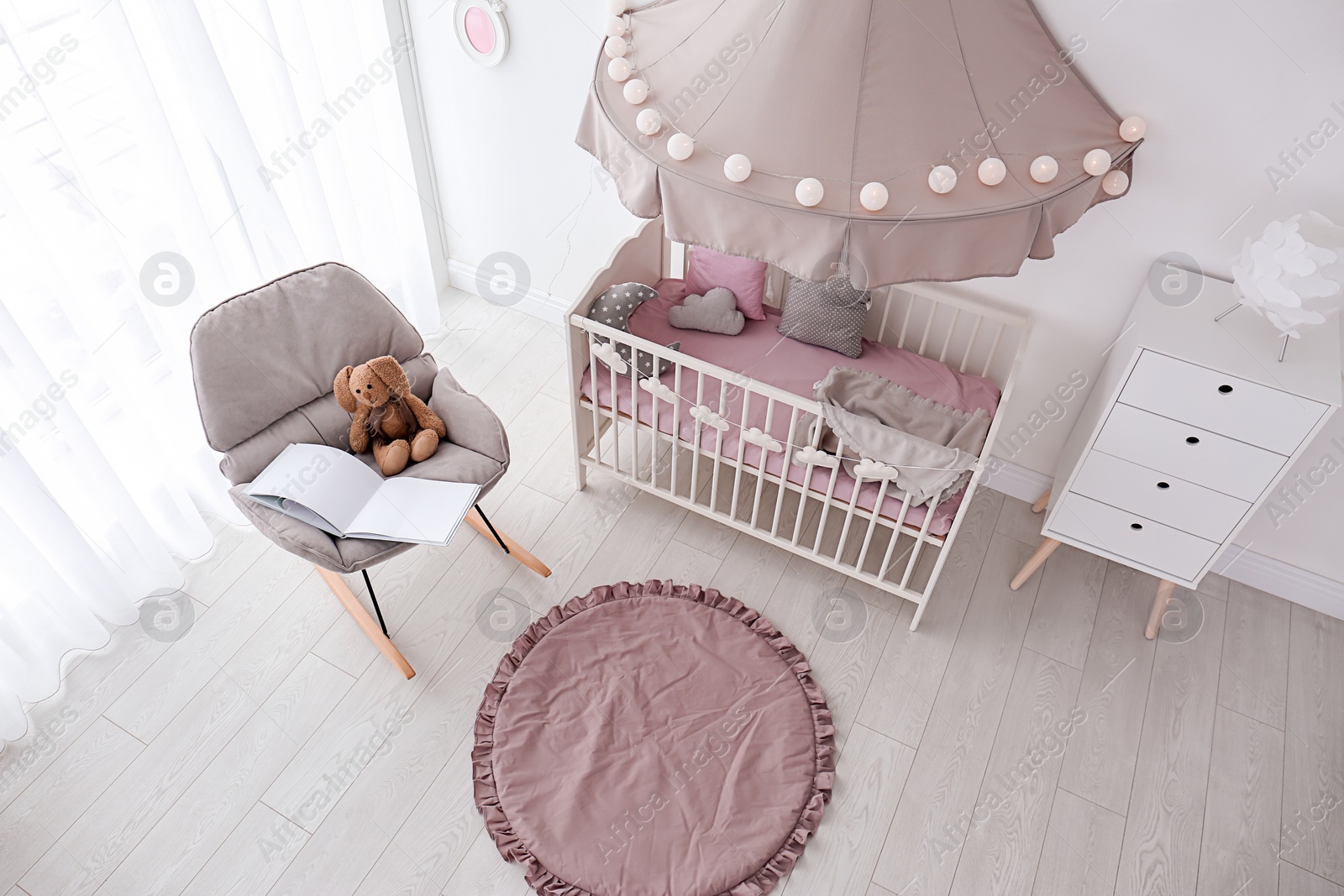 Photo of Interior of baby room with comfortable crib