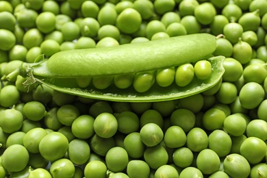 Photo of Many fresh green peas as background, closeup