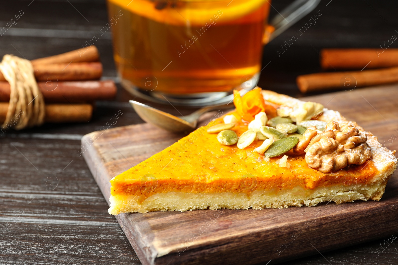 Image of Piece of fresh homemade pumpkin pie on wooden table