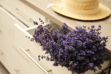 Photo of Beautiful fresh lavender flowers in drawer, closeup