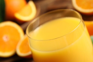 Photo of Glass of delicious fresh orange juice, closeup