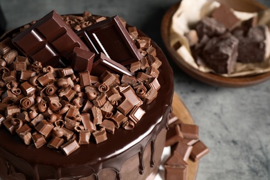 Freshly made delicious chocolate cake on grey table, closeup