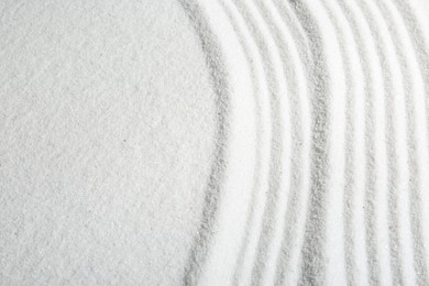 Photo of Zen rock garden. Wave pattern on white sand