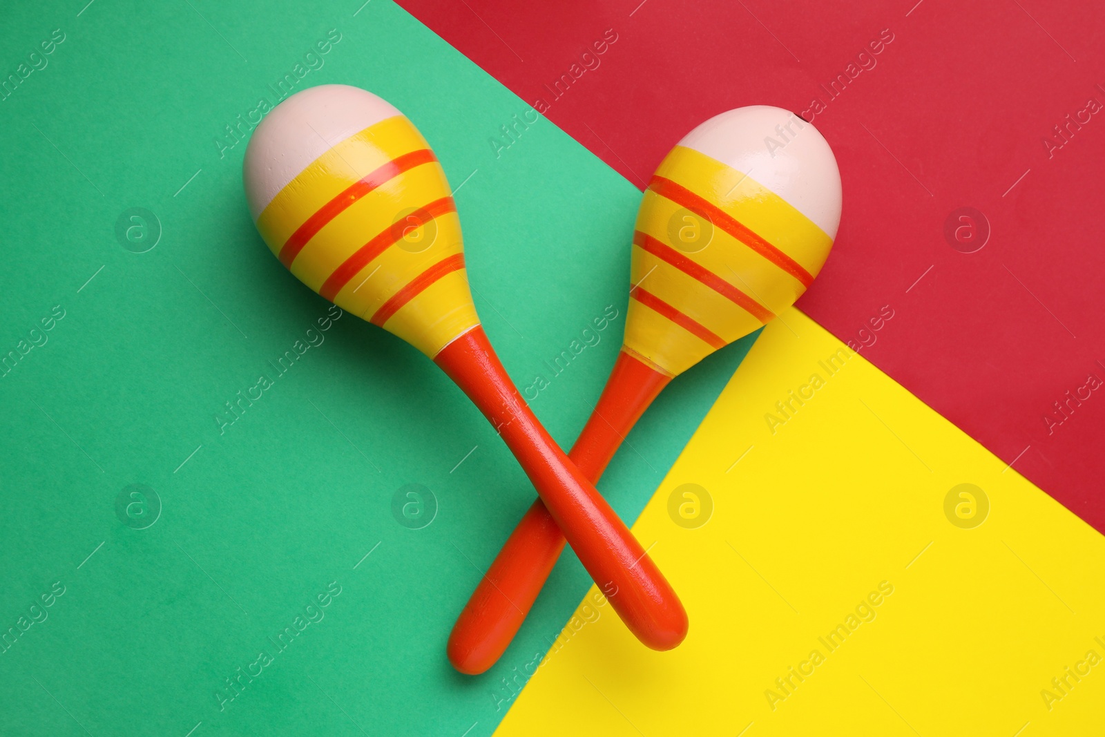 Photo of Maracas on colorful background, flat lay. Musical instrument