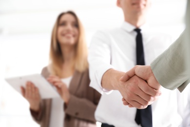 Photo of Business partners shaking hands after meeting, closeup. Space for text