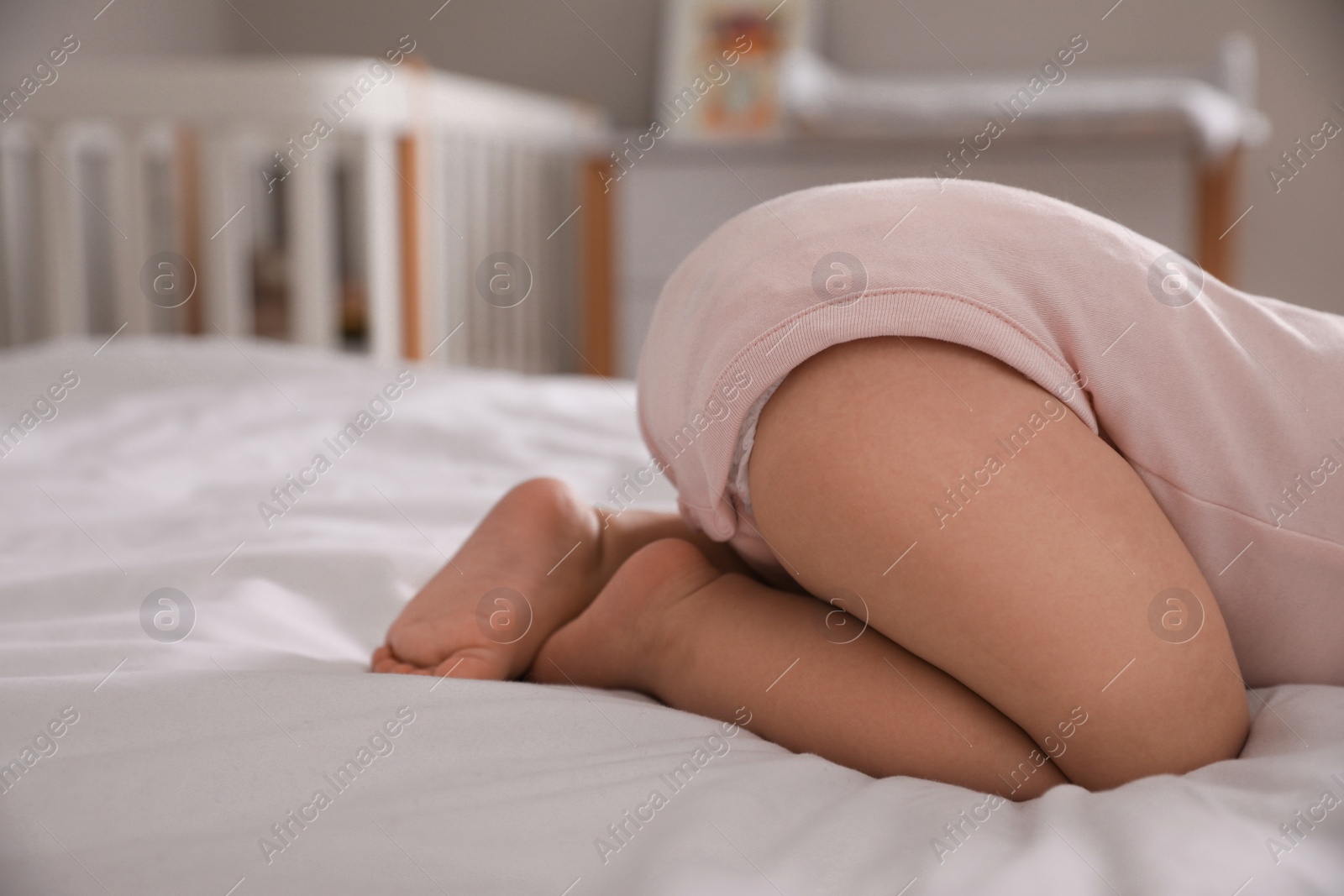 Photo of Adorable little baby sleeping on bed at home, closeup